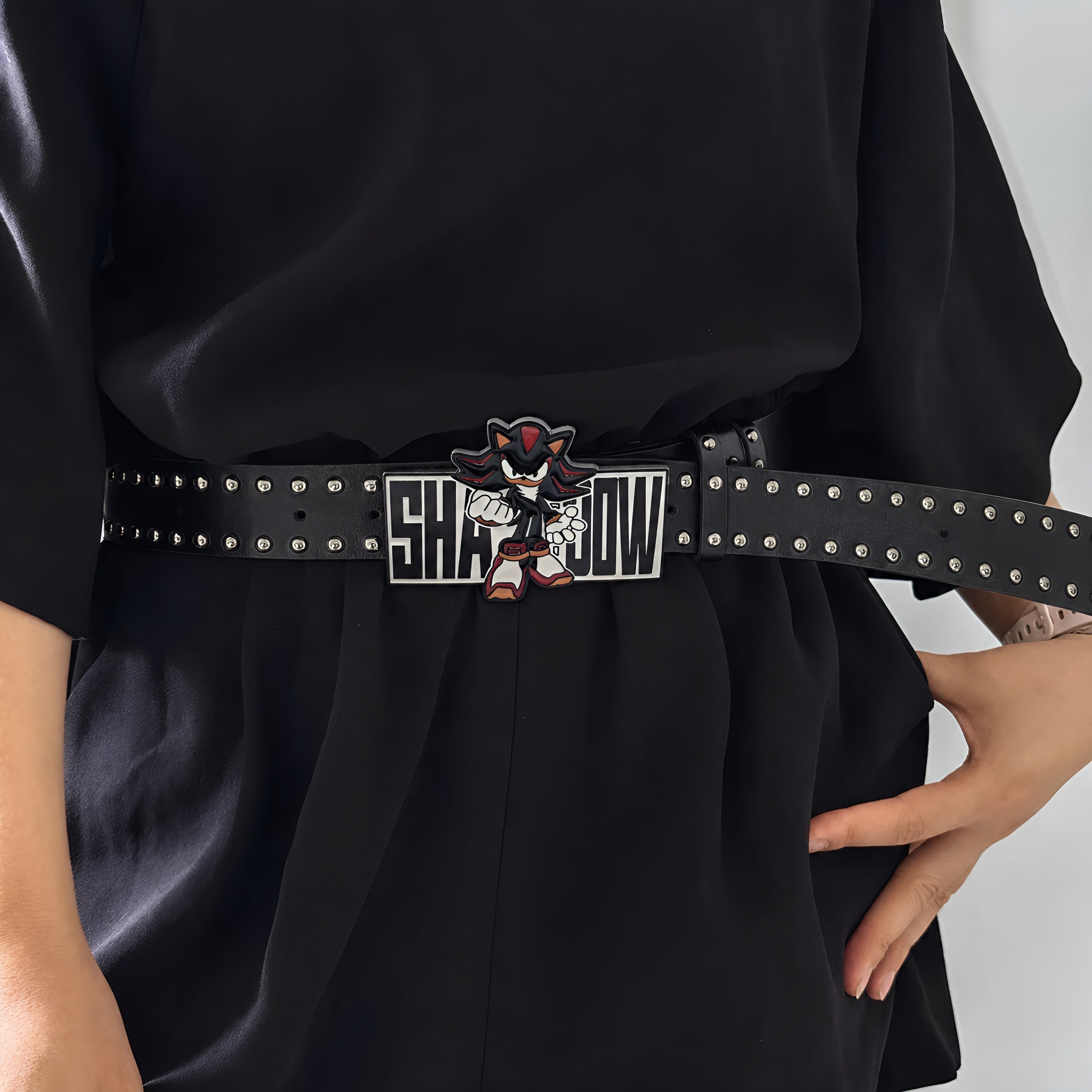 Model wearing Shadow Retro graphic buckle belt over a black outfit